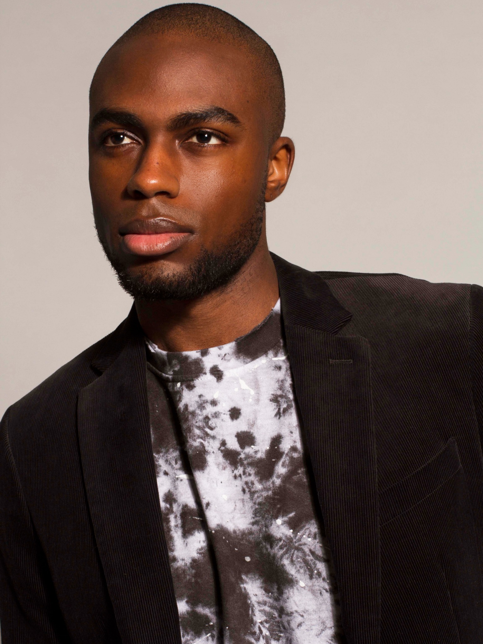 CJ Henry, founder of Red Ground Hair, wearing a black blazer
