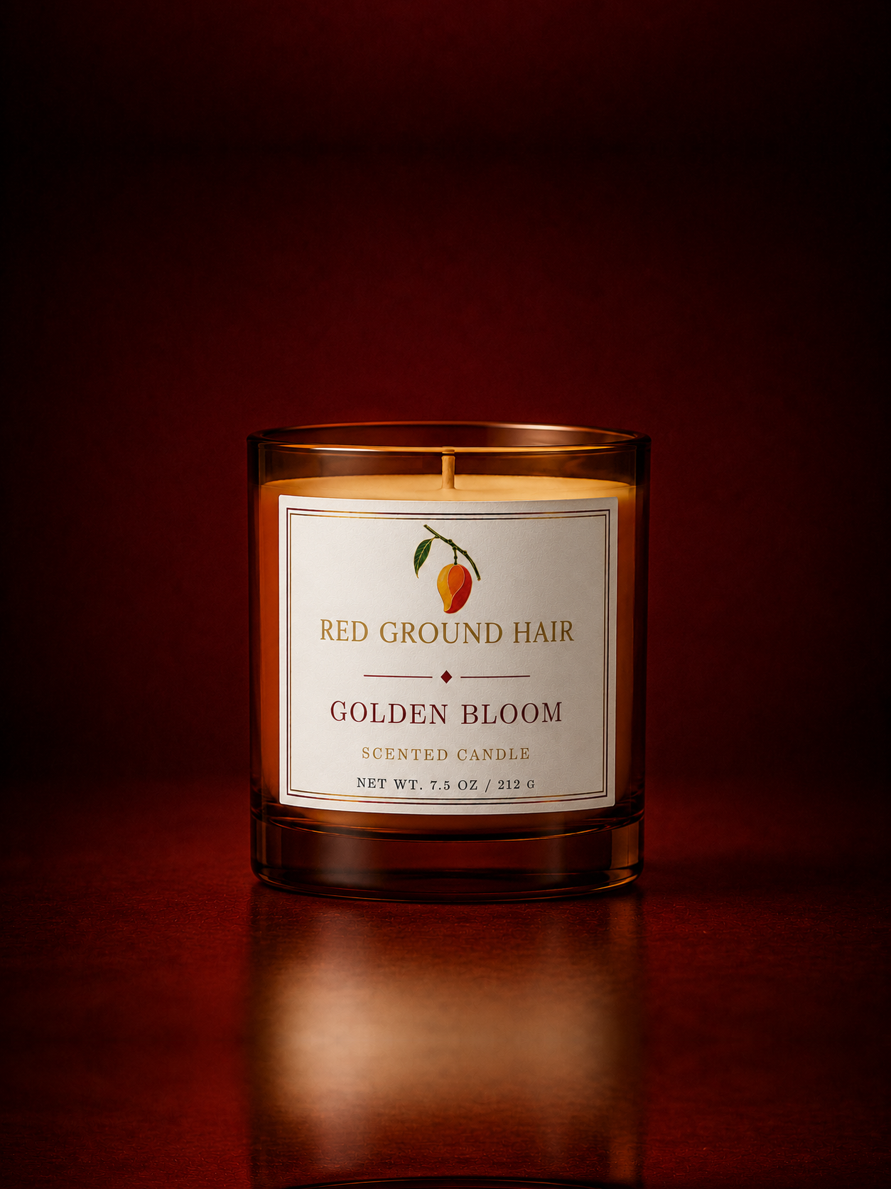 Lit Red Ground Hair Golden Bloom candle in an open amber glass jar